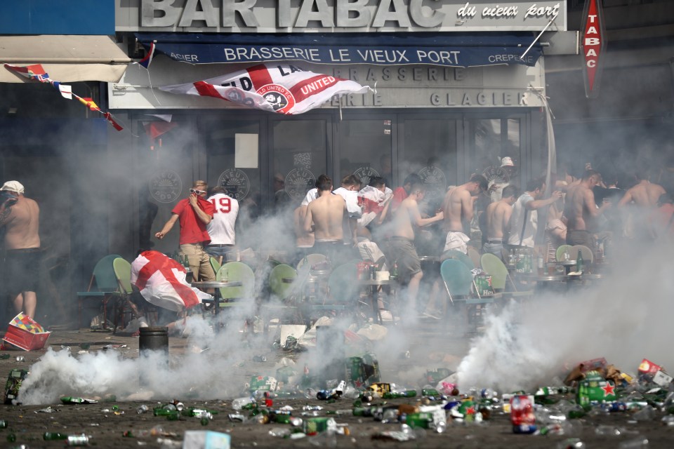 Torcedores da Inglaterra fogem do gás lacrimogêneo lançado por policiais depois de serem emboscados por torcedores russos na Euro 2016